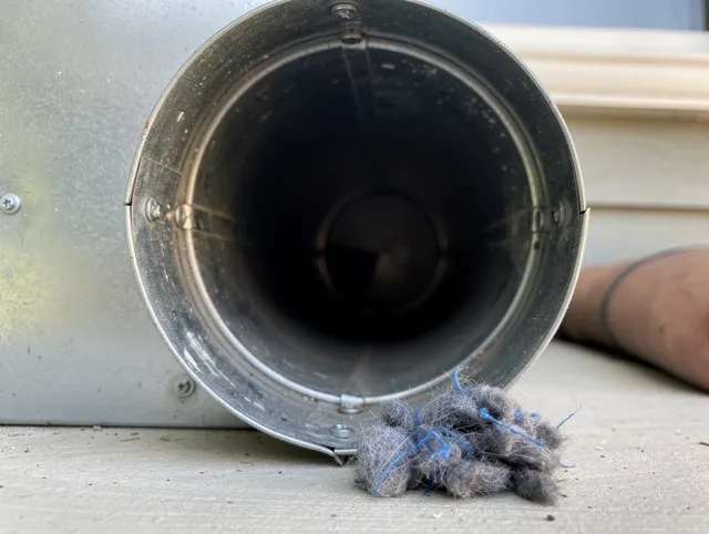 Southborough Dryer Vent Cleaning technician using specialized equipment to clear severe dryer vent blockage in Southborough